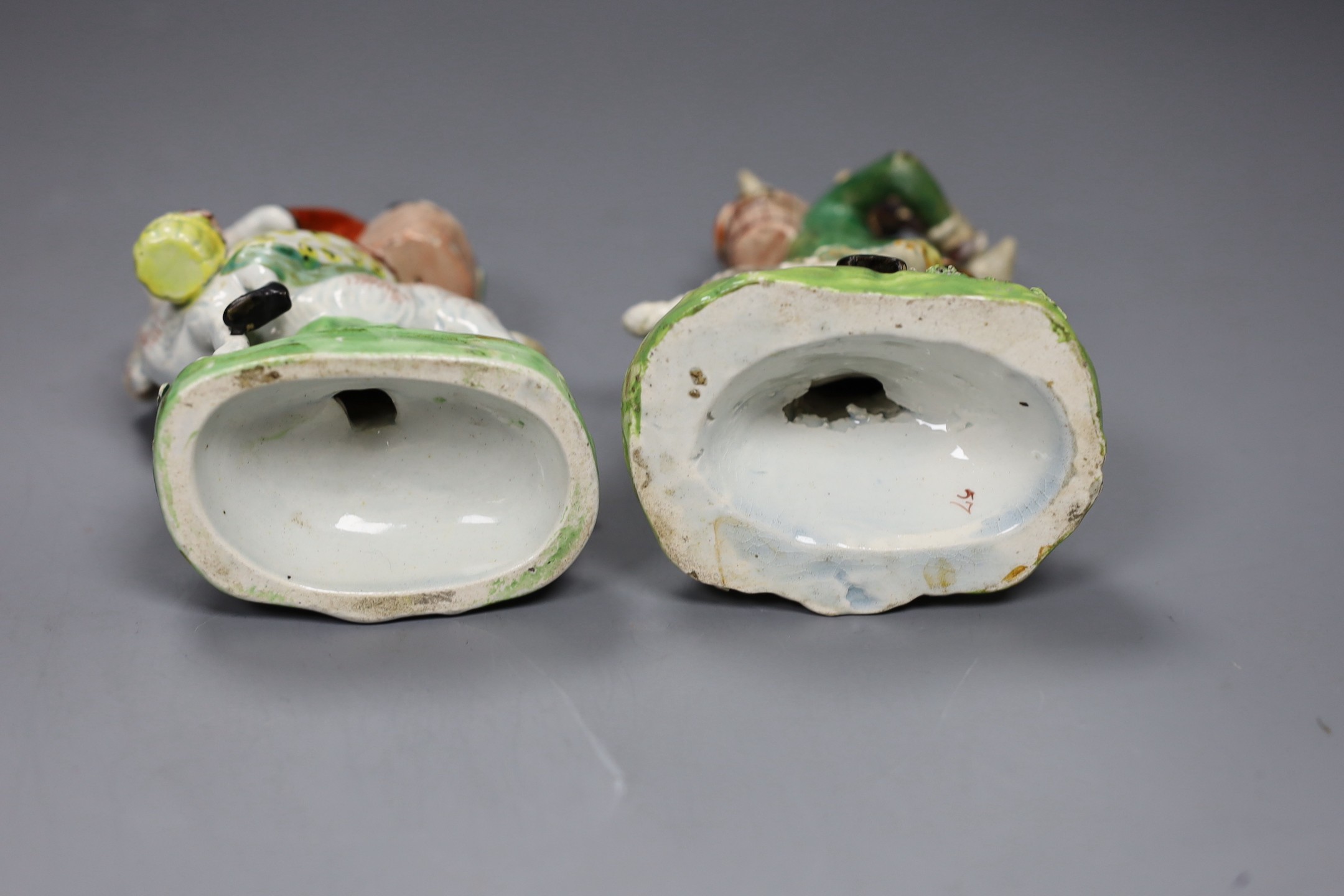 A near pair of pearlware groups Tailor and his wife, c.1820, tallest 13.5cm